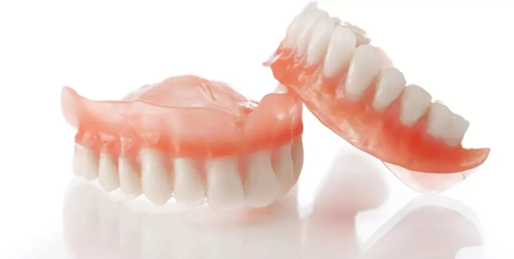 How long is the adjustment period for partial dentures?